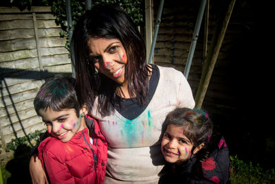 Portrait of woman with children covered in powder paints