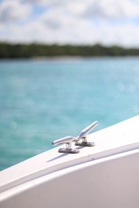 Close-up of boat on sea against sky