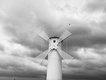 Low angle view of traditional windmill against sky