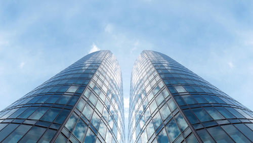 Low angle view of modern building against blue sky