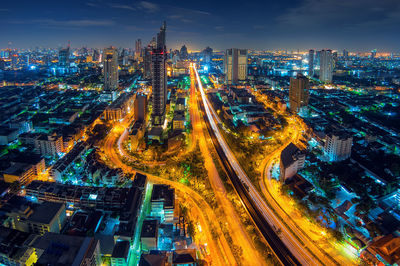 High angle view of city lit up at night