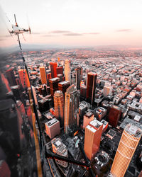 High angle view of buildings in city during sunset