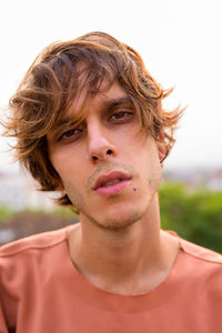 Portrait of young man against sky