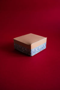 Gift box on a red background. craft paper and handmade decoration. high quality photo