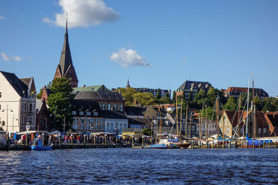 Buildings against sky with waterfront