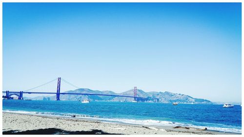 View of suspension bridge over sea