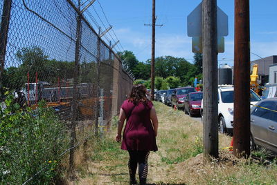 Rear view of women standing against trees