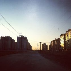 Road along buildings at sunset