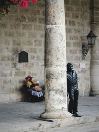 Man and woman statue against building