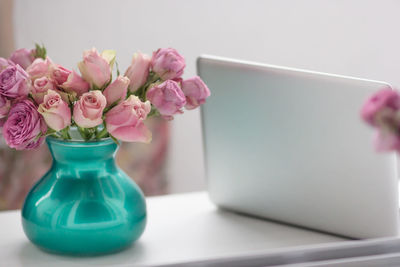 Close-up of pink rose flower vase on table