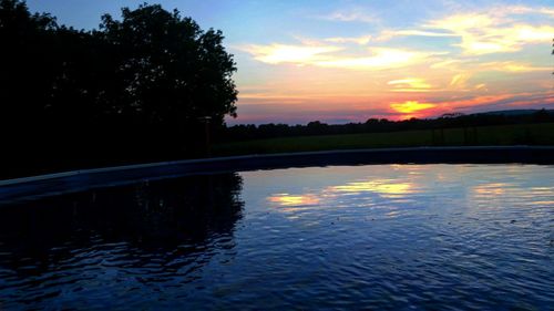 Scenic view of river at sunset