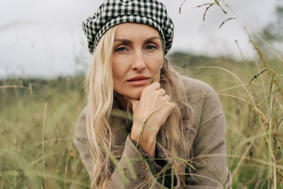 Portrait of young woman standing on field