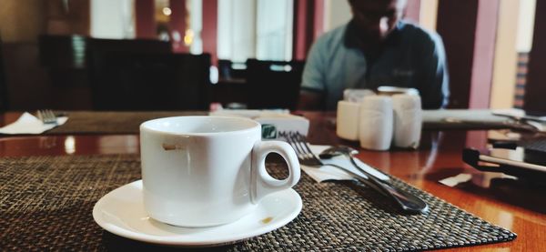 Coffee cup on table in cafe