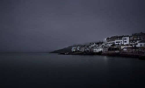 Town by sea against sky