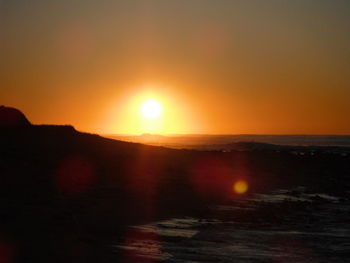 Scenic view of sea against orange sky