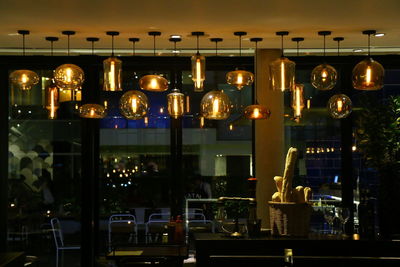 Illuminated lanterns hanging in restaurant