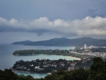 High angle view of townscape by sea against sky