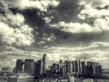 Cityscape against cloudy sky