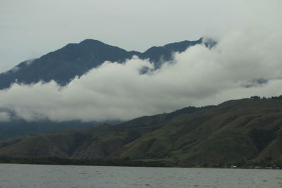 Scenic view of lake and mountains against sky