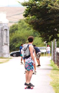 Rear view of men walking on friends