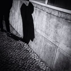 Shadow of woman on footpath