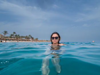 Portrait of woman swimming in sea