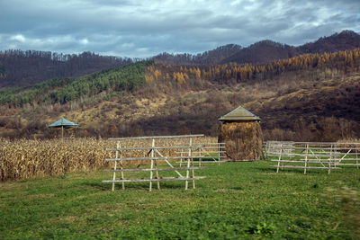 Built structure on field against sky