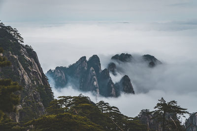 Scenic view of mountains against cloudy sky