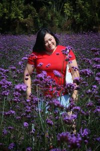 Woman with pink flowers on field