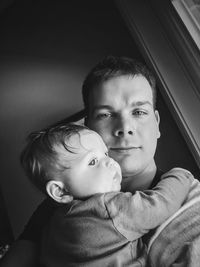 Portrait of father and son at home