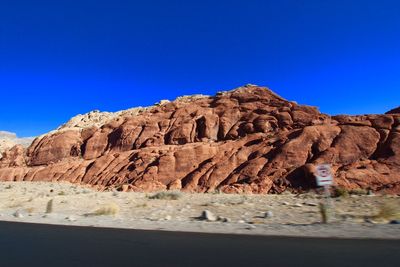 Rock formations in desert against clear blue sky