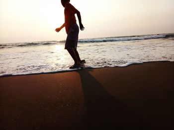 Full length of man on beach against sky