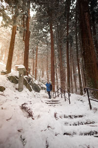 Woman on snow covered field during winter