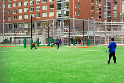 Men playing soccer in city