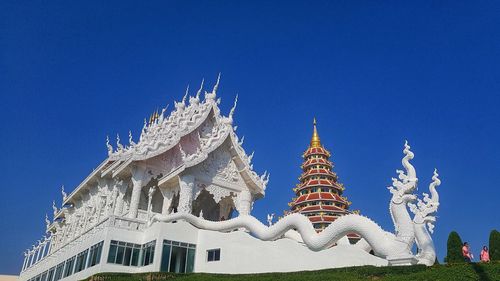 Low angle view of temple building against blue sky