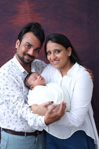 High angle view of mother and daughter lying on bed at home