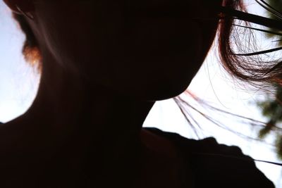 Close-up portrait of woman against sky