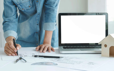 Midsection of man working on table