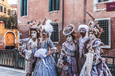 Panoramic shot of woman standing by mask in city