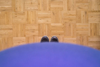 Low section of woman standing on tiled floor