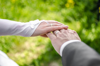 Cropped image of newlywed couple hands