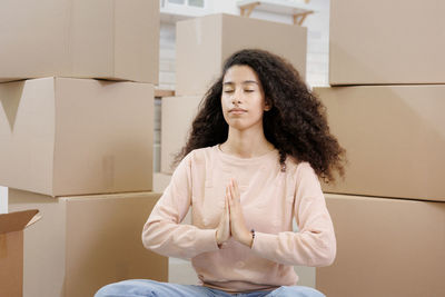 Portrait of young woman sitting on sofa at home