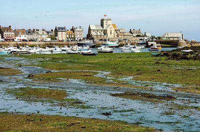 Boats in river with buildings in background