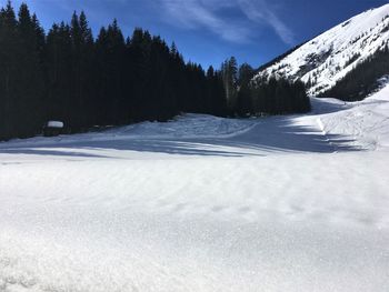 Snow covered landscape against sky