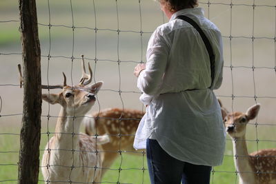 Women standing by fence in the park 