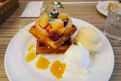 Close-up of dessert and ice creams served in plate on table