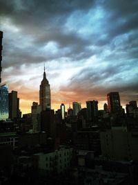 Modern cityscape against cloudy sky