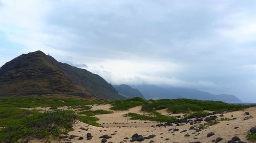 Scenic view of mountains against cloudy sky