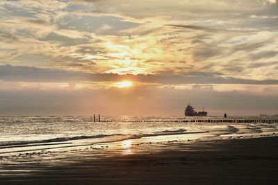 Scenic view of beach against sky during sunset