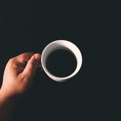 Cropped image of hand holding coffee cup
